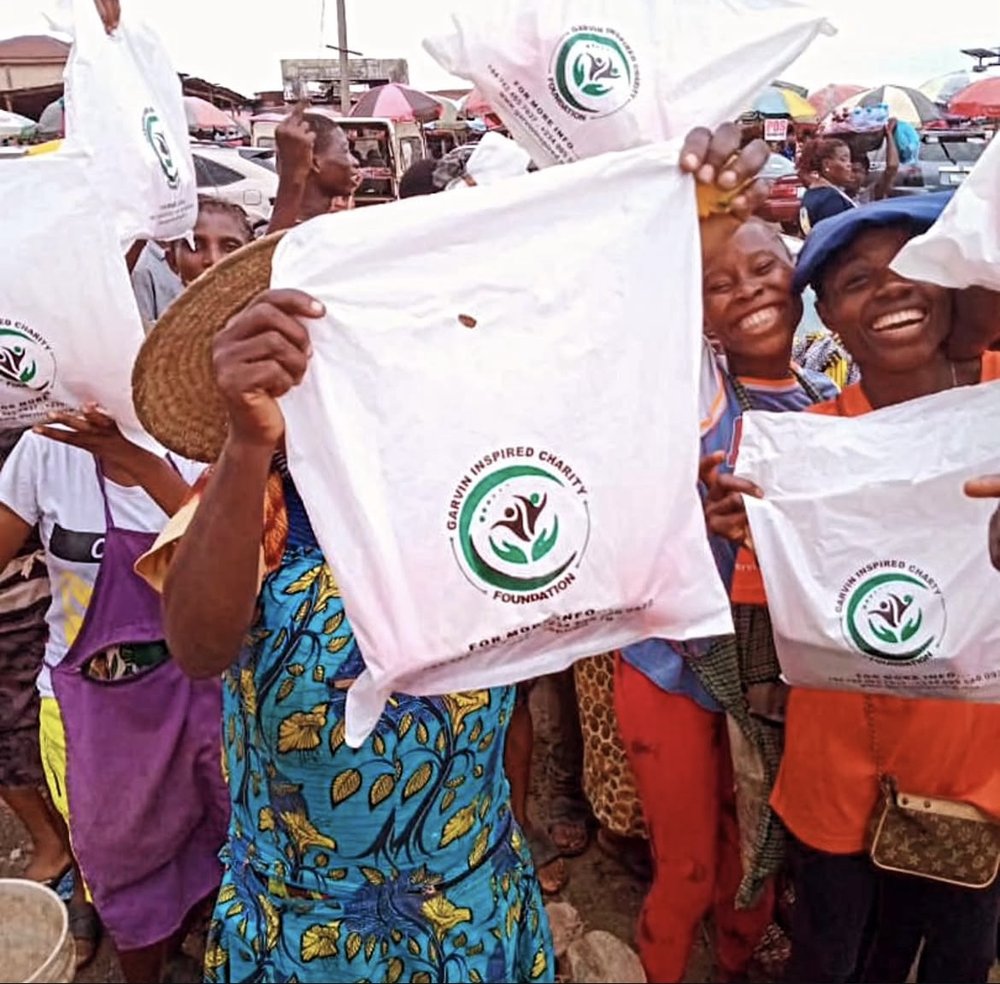 Community members holding Garvin Inspired relief bags